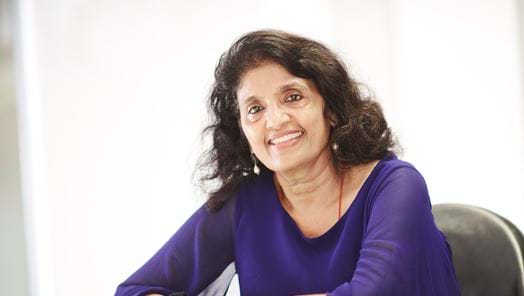 ScreenSkills CEO Seetha Kumar sat smiling at desk