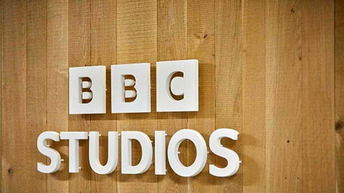 BBC Studios logo on a wooden panelled wall