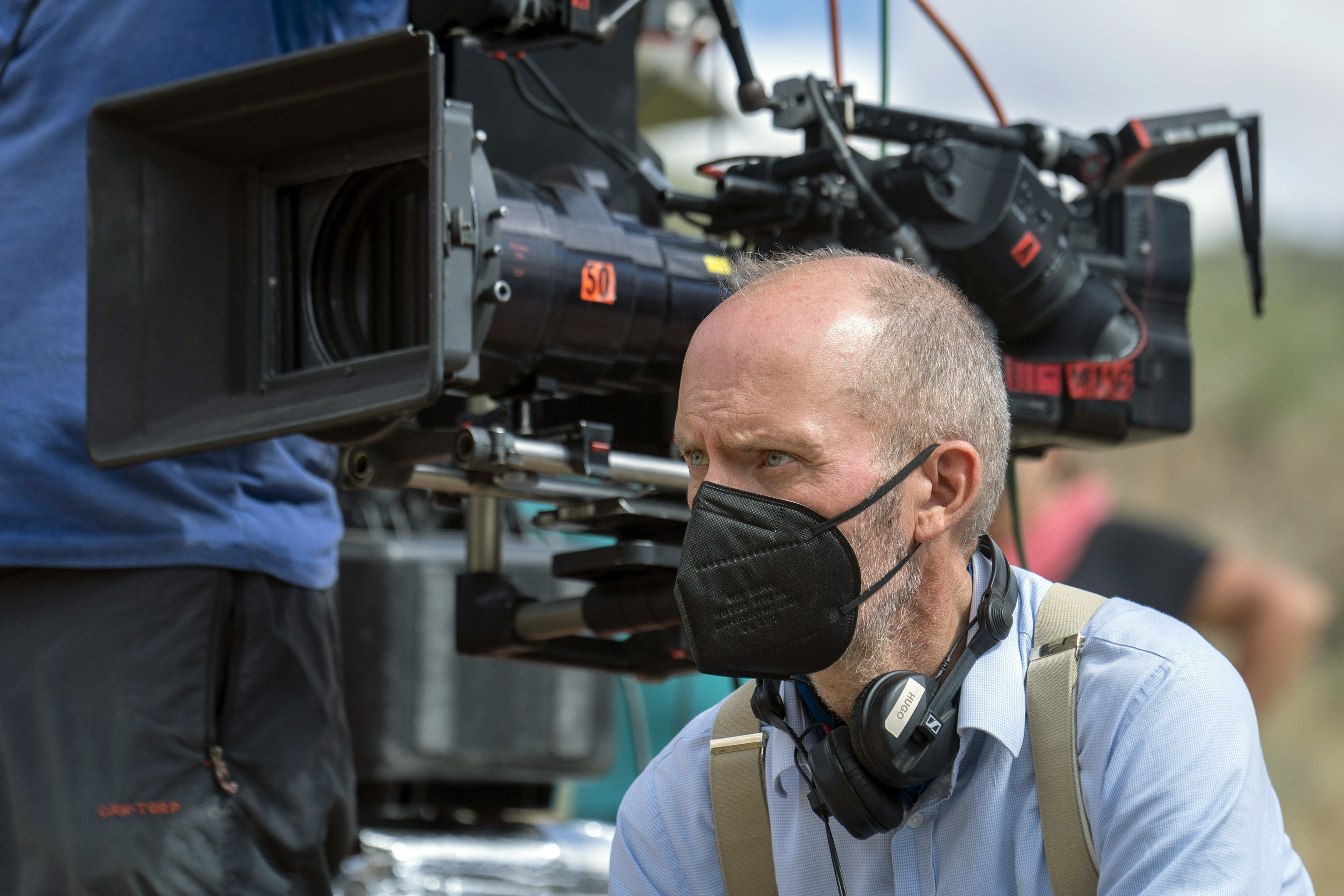 Man sitting next to a camera
