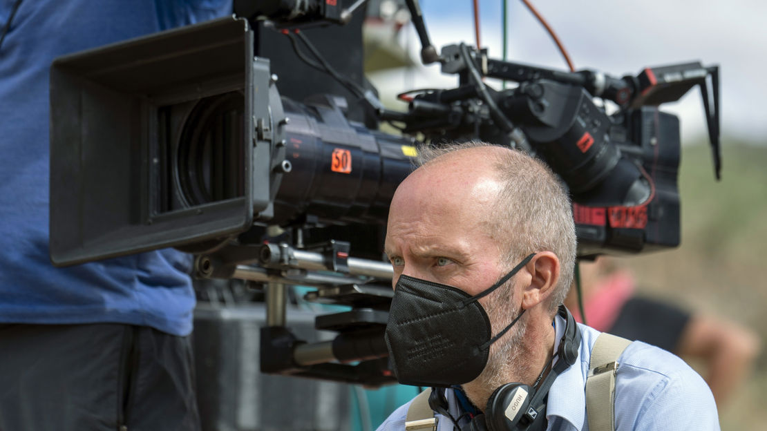 Man sitting next to a camera
