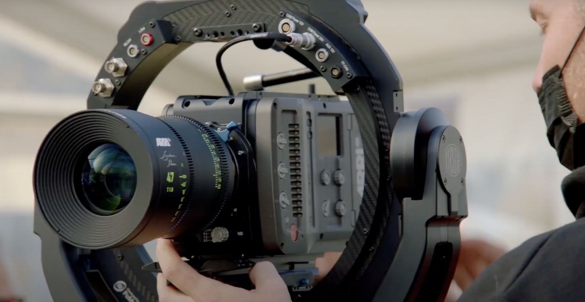A camera operator holding a camera on a circular rig
