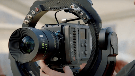 A camera operator holding a camera on a circular rig