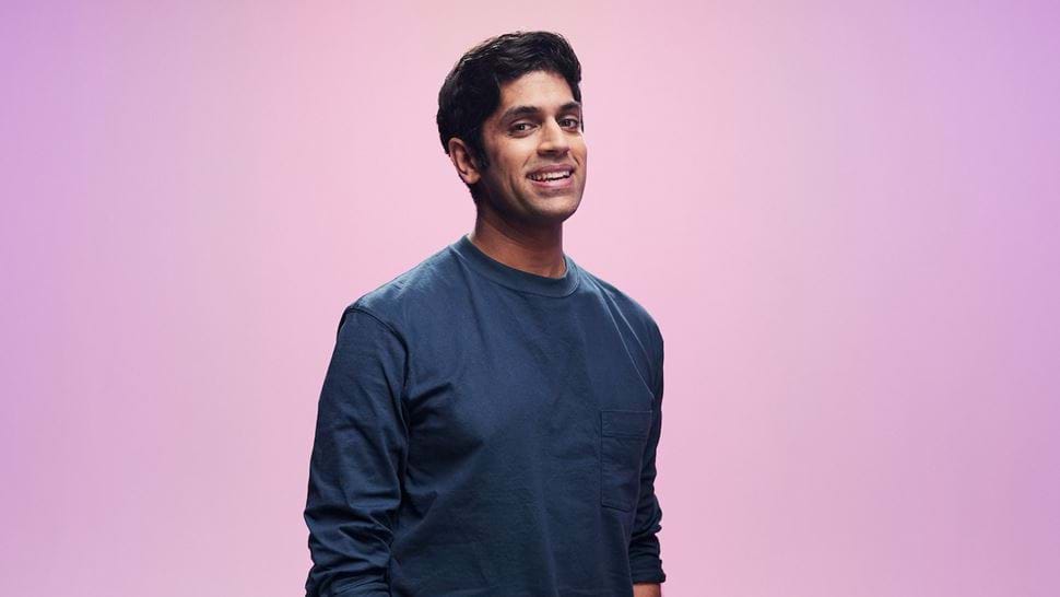 Faraz Osman stands in front of a pink background