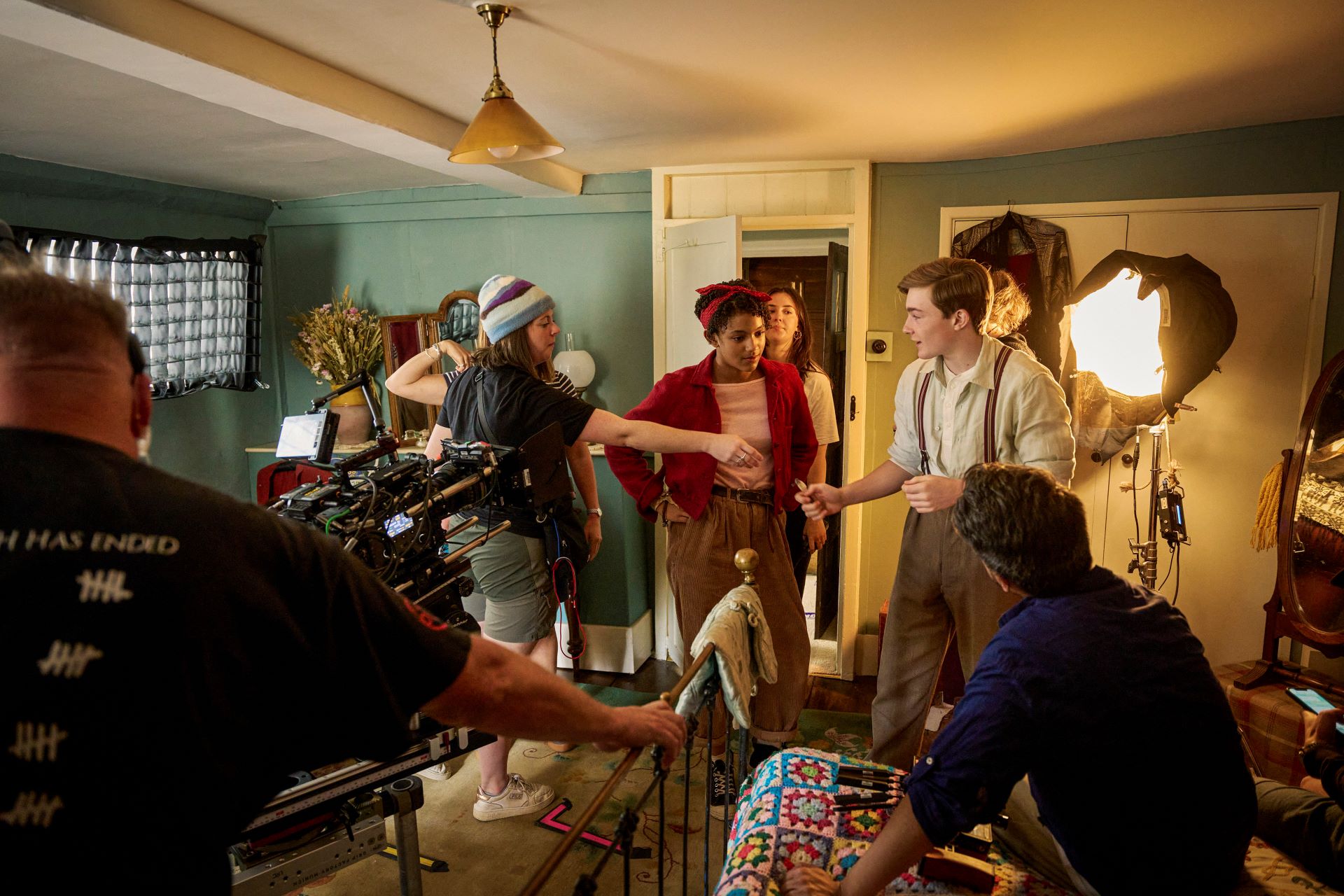 Actors and members of production crew shoot an indoor scene of a children's TV show