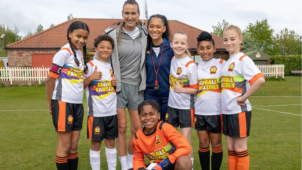 Ex-Lioness footballer Jill Scott with the young cast of Football Fantastics dressed in football kit