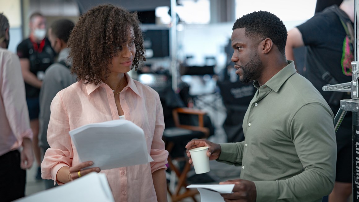 A BTS shot from Lift where two actors standing talking