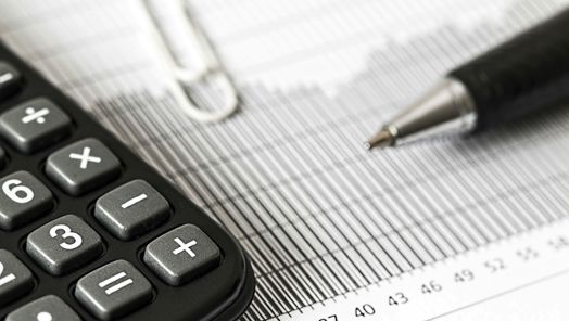 Close up of  a calculator, pen and other stationary