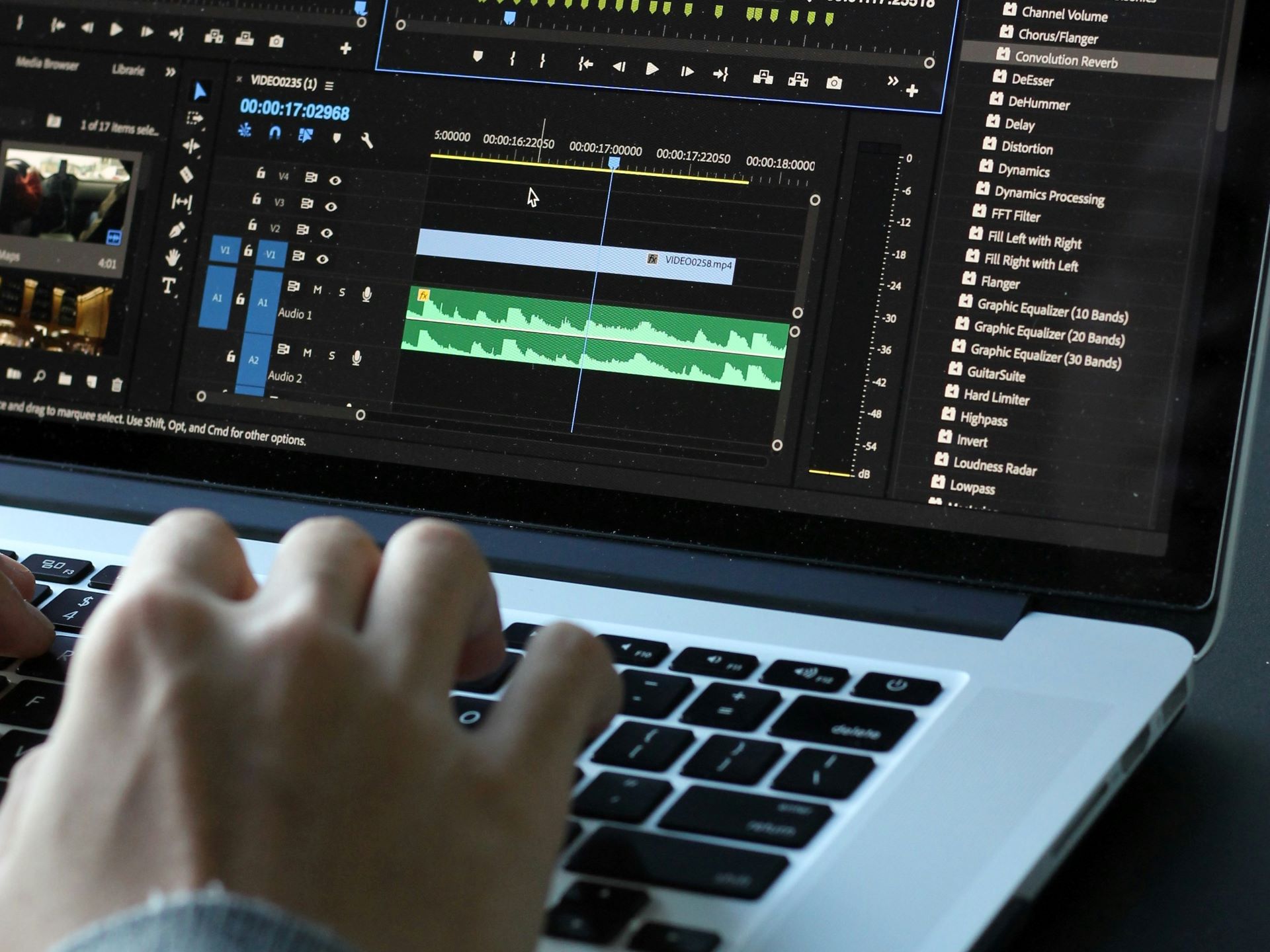 Closeup of someone editing a video in a video editing software on a laptop